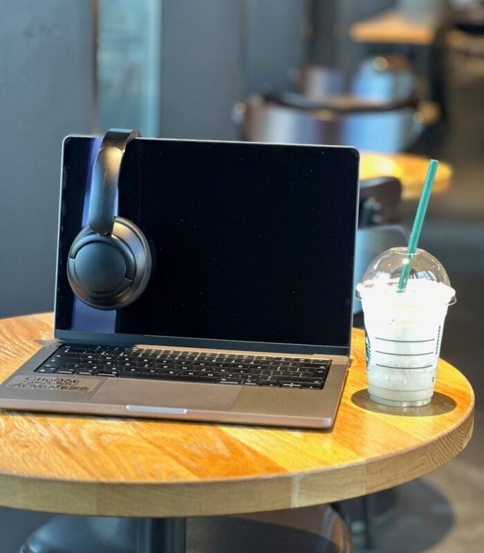 a laptop computer sitting on top of a wooden table